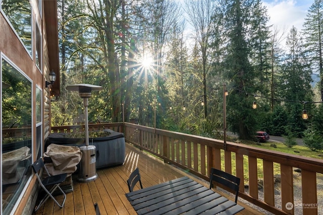 wooden deck featuring a hot tub