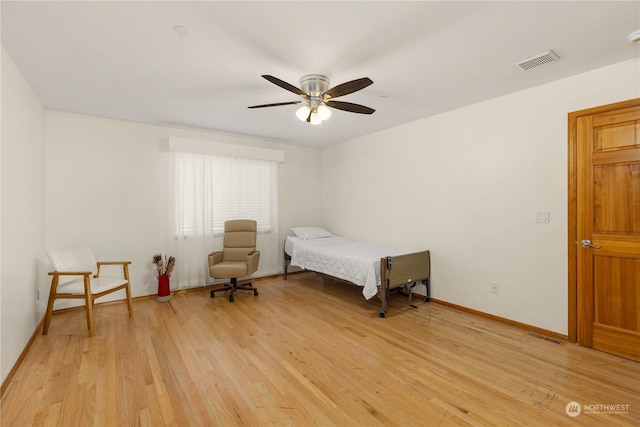 bedroom with ceiling fan and light hardwood / wood-style floors