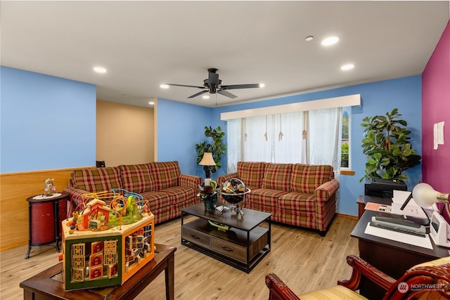 living room with light hardwood / wood-style floors and ceiling fan