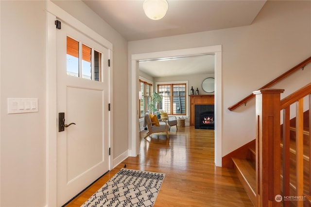 foyer featuring hardwood / wood-style floors and a tile fireplace