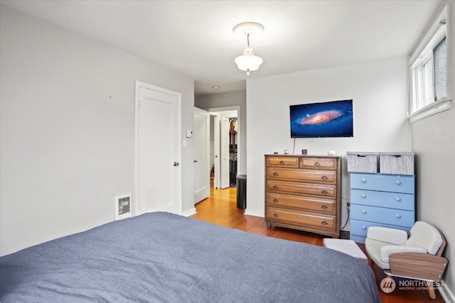 bedroom featuring light wood-type flooring and a closet