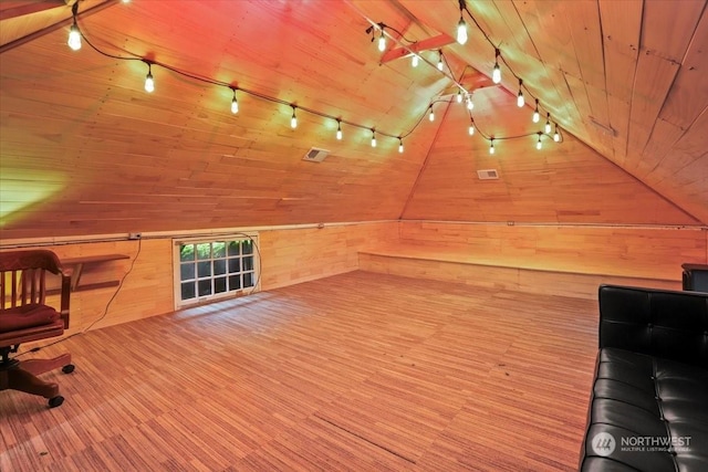 additional living space featuring wood walls and wooden ceiling