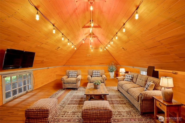 interior space featuring vaulted ceiling, wooden ceiling, and wood walls