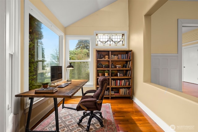 home office with vaulted ceiling, wood finished floors, and baseboards