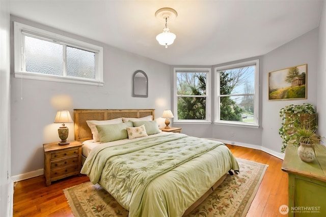 bedroom with baseboards and wood-type flooring