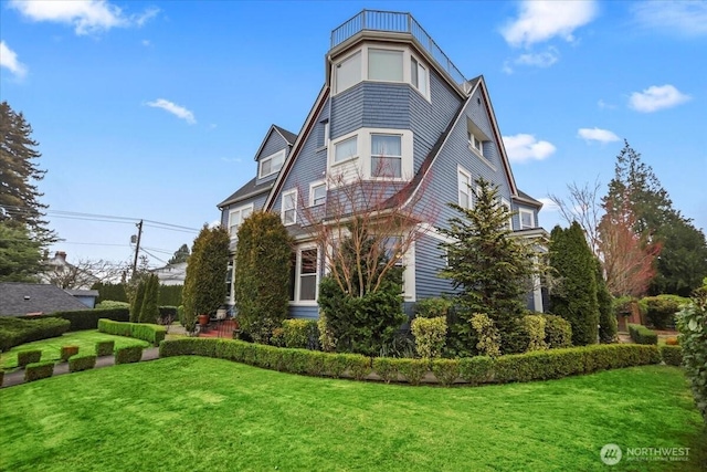 view of side of home with a yard