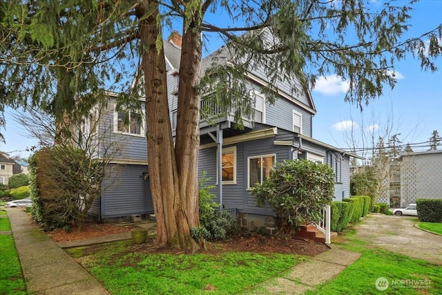 view of property exterior featuring a chimney