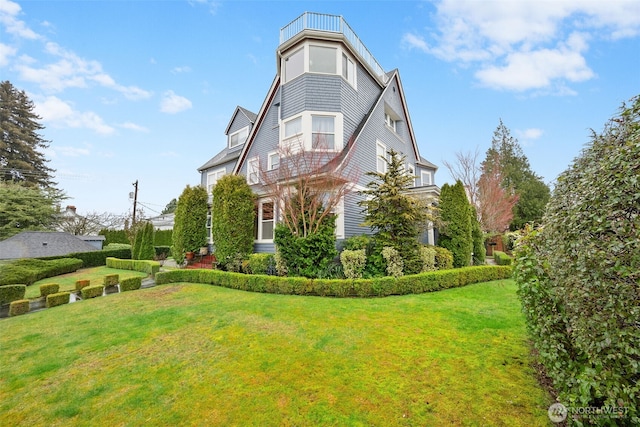 view of side of home featuring a lawn