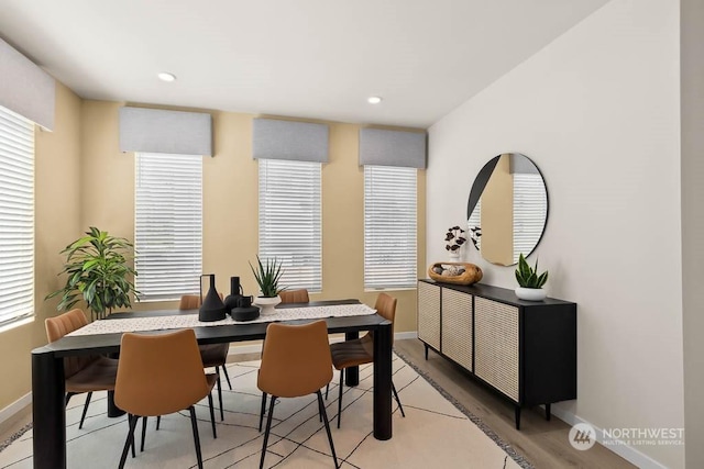 dining space with light wood-type flooring and a wealth of natural light