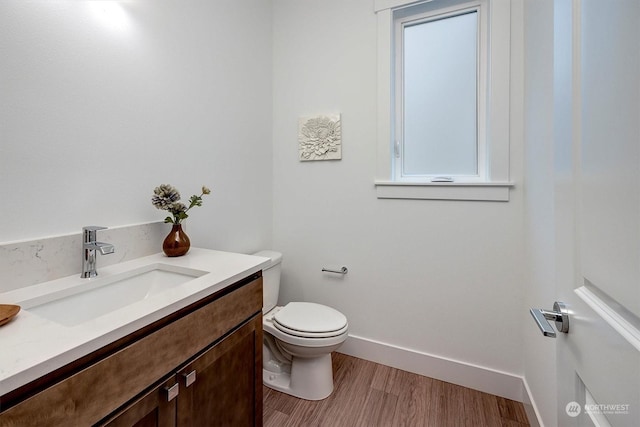 bathroom featuring hardwood / wood-style floors, toilet, and vanity