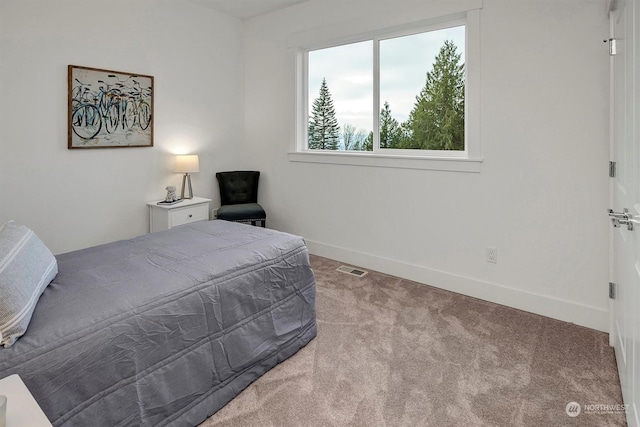 bedroom featuring light colored carpet