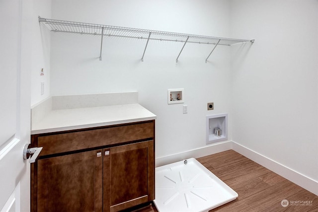 laundry room featuring hookup for a washing machine, wood-type flooring, and electric dryer hookup