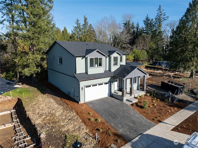 view of front of property with driveway, a shingled roof, a garage, and board and batten siding