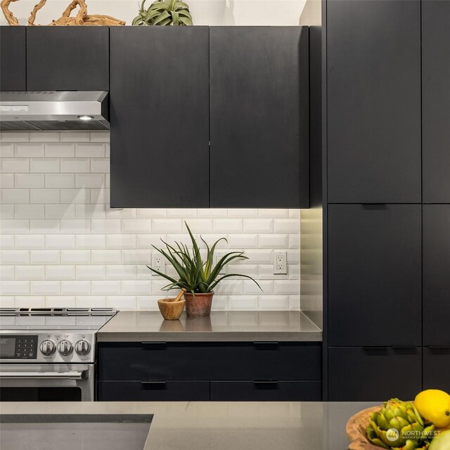 kitchen with wall chimney exhaust hood, stainless steel electric range oven, and tasteful backsplash
