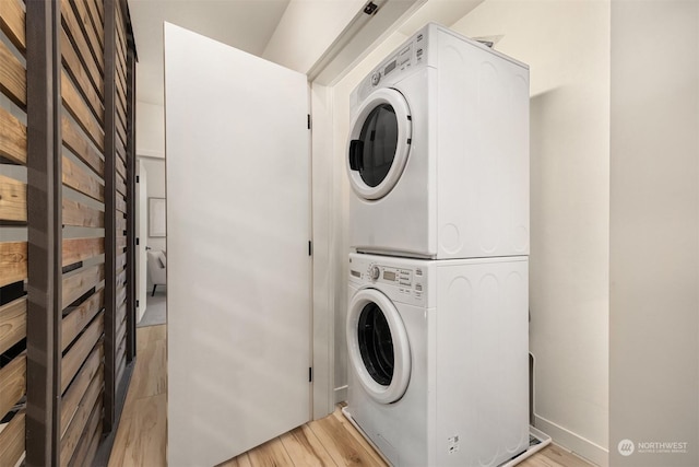 washroom featuring stacked washer / drying machine and light wood-type flooring