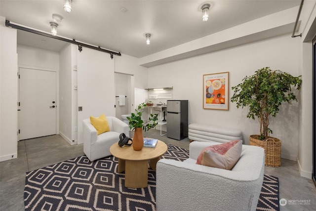 living room featuring concrete flooring and a barn door