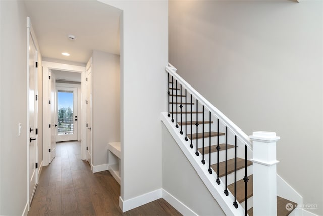 staircase with hardwood / wood-style flooring