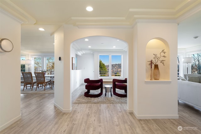 hall with crown molding and light hardwood / wood-style floors