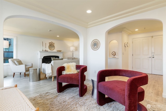 sitting room featuring light hardwood / wood-style flooring and crown molding