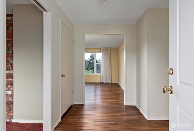 hallway with dark hardwood / wood-style flooring