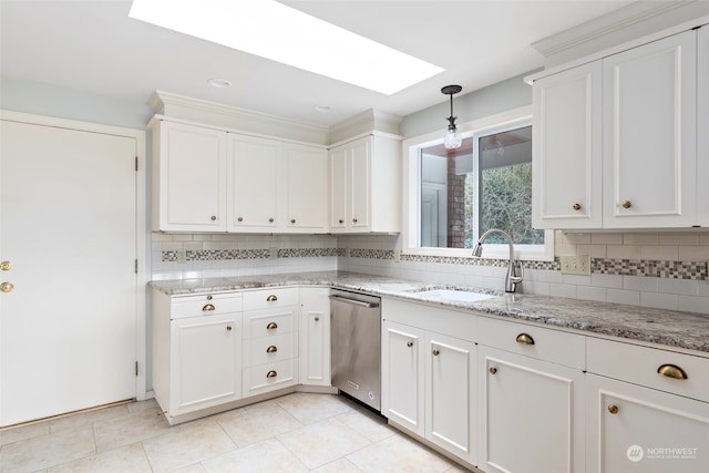 kitchen with a skylight, dishwasher, sink, white cabinets, and light stone counters