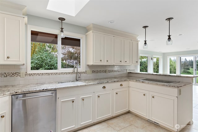 kitchen with a skylight, dishwasher, black electric stovetop, and decorative light fixtures