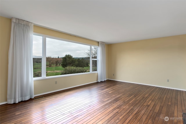 unfurnished room with dark hardwood / wood-style floors