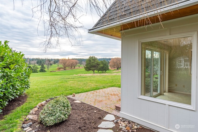 view of yard with a rural view and a patio area