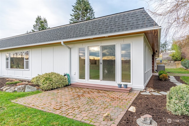 back of property featuring central AC unit and a patio