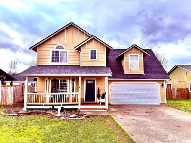 view of front facade with covered porch, a front lawn, and a garage