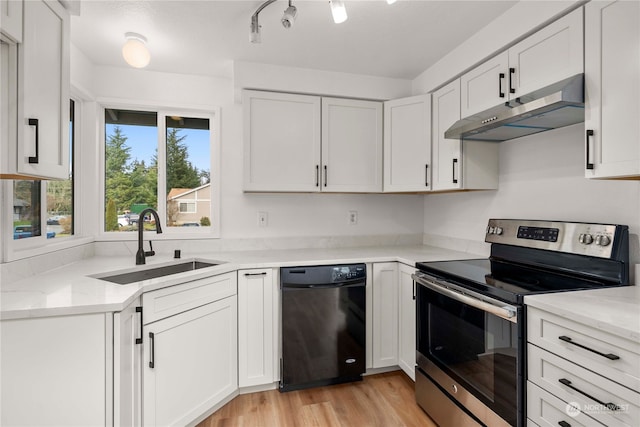 kitchen with electric stove, light hardwood / wood-style floors, sink, black dishwasher, and white cabinetry