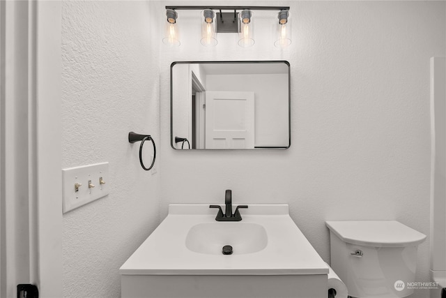 bathroom with toilet and vanity