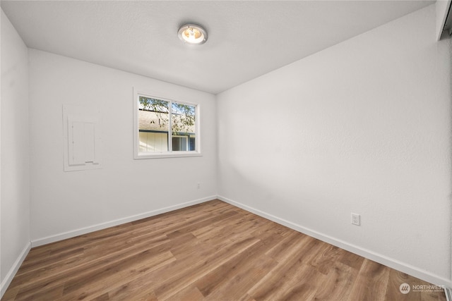 spare room featuring wood-type flooring