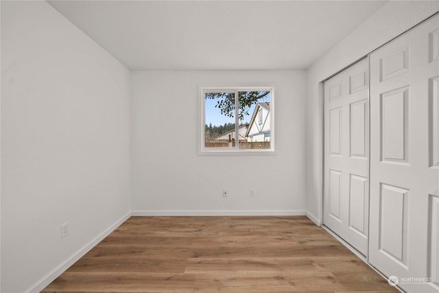 unfurnished bedroom featuring a closet and light hardwood / wood-style flooring