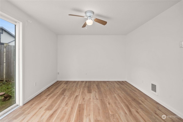 empty room with ceiling fan and light wood-type flooring