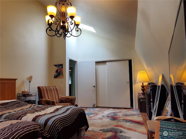 bedroom featuring lofted ceiling, a closet, and a notable chandelier