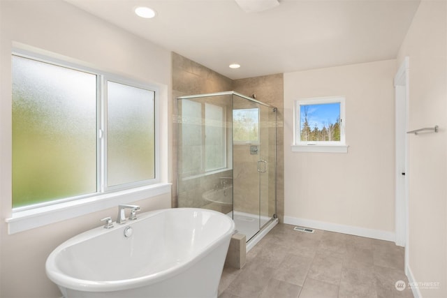 bathroom featuring independent shower and bath and tile patterned flooring