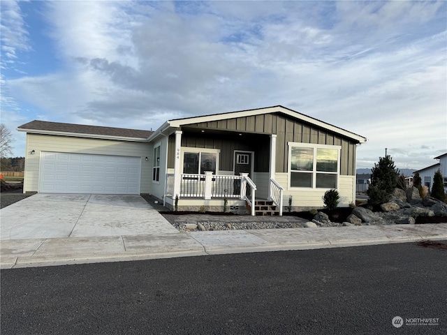 manufactured / mobile home featuring a garage and covered porch