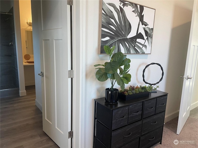 corridor with hardwood / wood-style floors