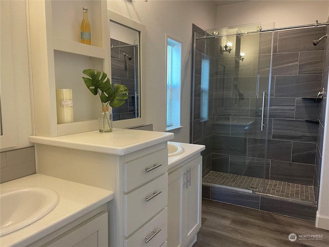 bathroom featuring hardwood / wood-style flooring, vanity, and an enclosed shower