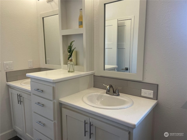 bathroom featuring vanity and decorative backsplash