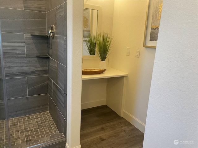 bathroom featuring tiled shower and hardwood / wood-style floors