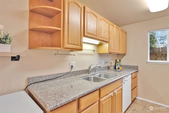 kitchen featuring dishwasher, light brown cabinets, and sink