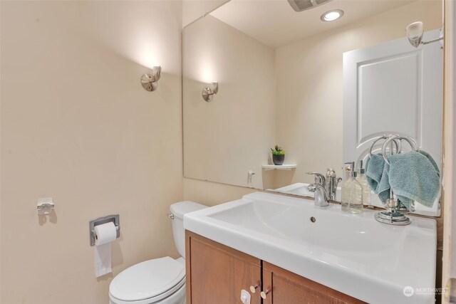 bathroom featuring toilet and vanity