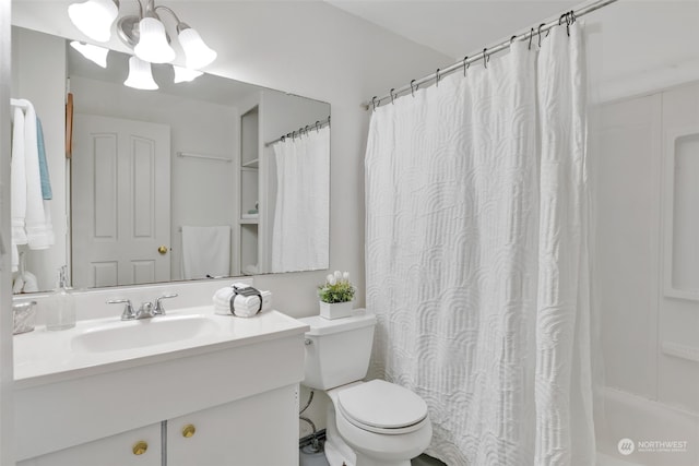 bathroom with a chandelier, toilet, vanity, and a shower with curtain