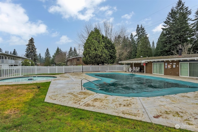 view of pool with a lawn and a patio area