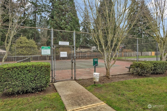 exterior space with a lawn and basketball hoop