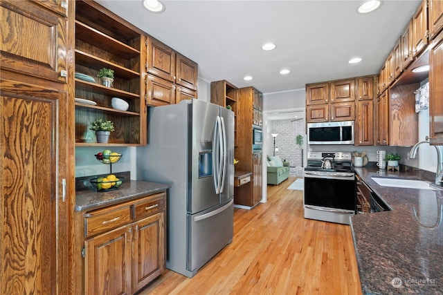 kitchen with light hardwood / wood-style flooring, sink, and stainless steel appliances