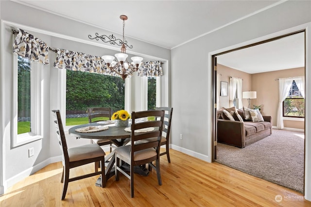 dining room with ornamental molding, a chandelier, and wood-type flooring