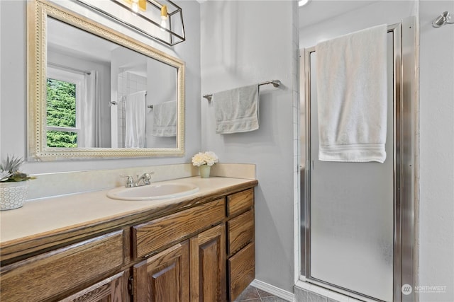 bathroom with vanity and a shower with shower door